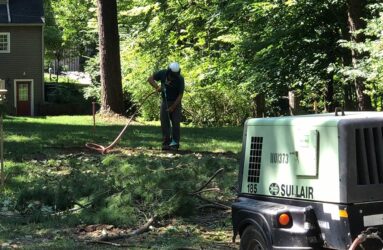 Arborist cutting a trench with air knife