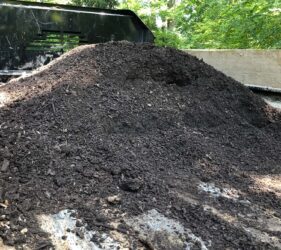 pile of compost and soil amendments in pickup truck bed