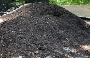 pile of compost and soil amendments in pickup truck bed
