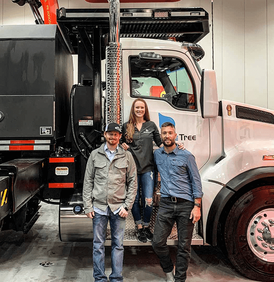 Bluestone Tree team members standing in front of a professional arborist service truck