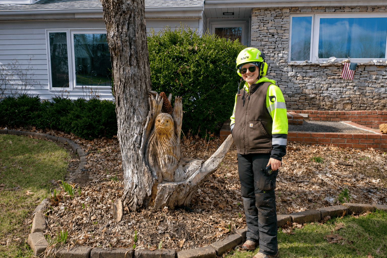 Photo of a tree care professional in safety gear performing tree work, illustrating what to look for when hiring a tree service in Bloomington, Indiana.